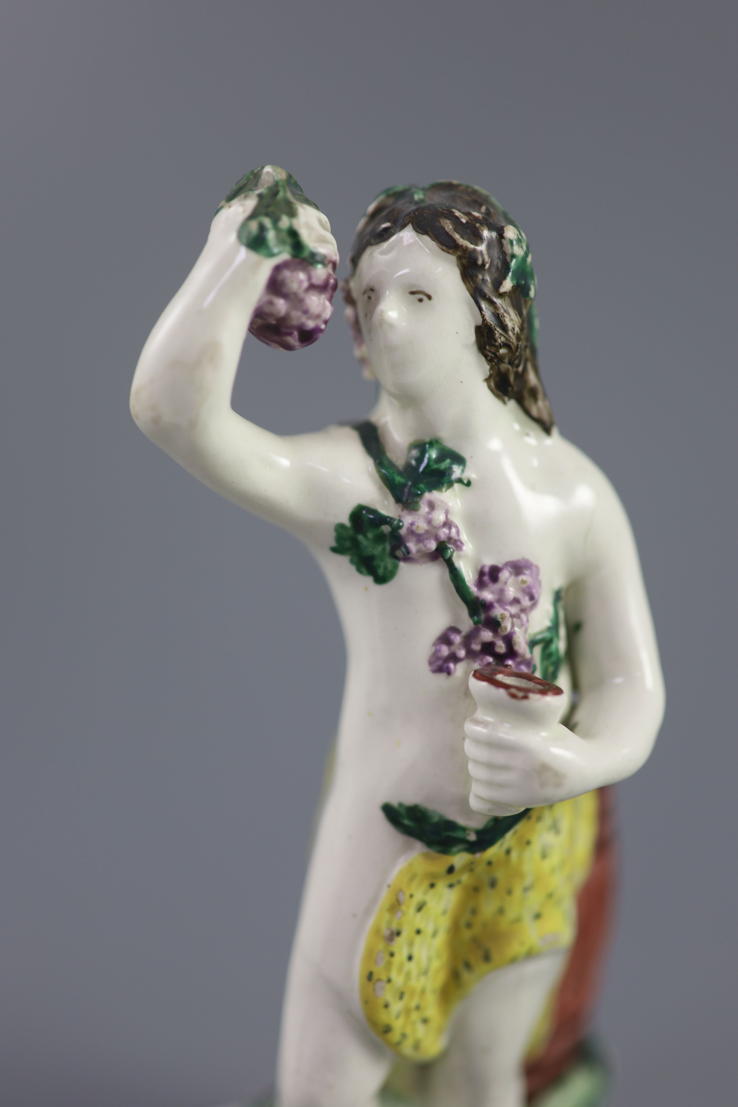 An enamelled creamware figure of Bacchus, attributed Leeds Pottery, c.1790-1800, 17.5cm high